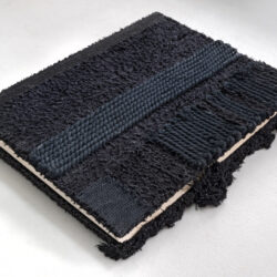 Black Book (front cover), 2025, 15 x 13 x 2", repurposed album (paper, board, book cloth), assorted cord/yarn, netting