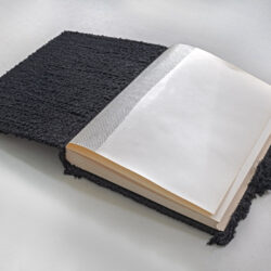 Black Book (interior), 2025, 15 x 13 x 2", repurposed album (paper, board, book cloth), assorted cord/yarn, netting